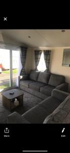 a living room with a couch and a coffee table at Crimdon dene holiday park clifftop park in Hartlepool