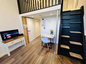 a room with a desk and a table with a chair at Apartment 6 Sullivan House in Hereford