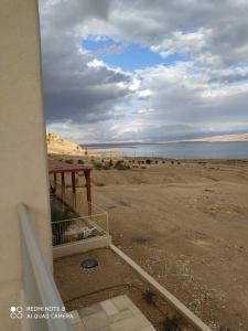 a balcony of a building with a view of the ocean at A romantic zimmer on the dead sea in Ovnat