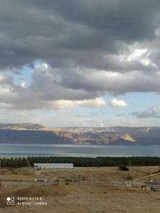 a view of a large body of water with a truck at A romantic zimmer on the dead sea in Ovnat