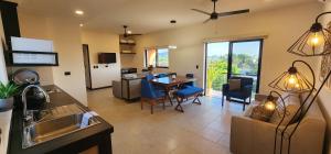 a kitchen and living room with a table and chairs at SUITES LOMBOY & PLAZA in San José del Cabo