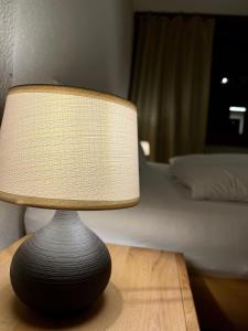 a lamp sitting on a table in a bedroom at Breathtaking Waterfall Apartment nr.2 in Lauterbrunnen +9 photos