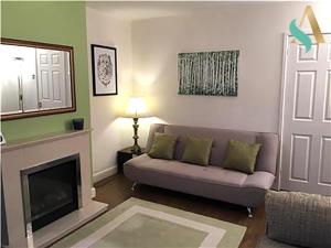 a living room with a couch and a fireplace at South View TSAC in Billingham