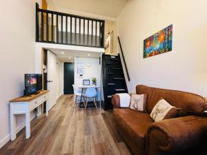a living room with a couch and a table at Apartment 7 Sullivan House in Hereford