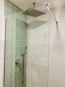 W łazience znajduje się prysznic ze szklanymi drzwiami. w obiekcie Flamenca Triana - Apartamento Totalmente Equipado Wifi 2D sofas camas 2 baños w Sewilli
