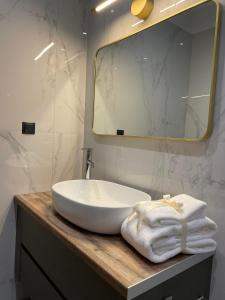 a bathroom with a white sink and a mirror at October Luxury Apartments Studio in Ioannina