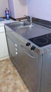 a stainless steel kitchen counter with a sink at Ferienwohnung Lassendorf in Hermagor