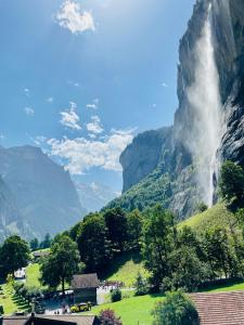 a view of a waterfall in the mountains at Breathtaking Waterfall Apartment in Lauterbrunnen