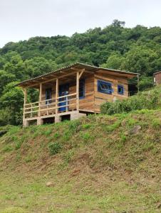 a wooden house on top of a hill at Bangalô dos Araçás - sítio Vô Haack in Gramado