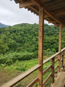 a view from the porch of a wooden house overlooking a mountain at Bangalô dos Araçás - sítio Vô Haack in Gramado +4 photos