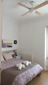 a bedroom with a bed with a ceiling fan at FLORIT FLATS - The Ausias March Apartment in Valencia