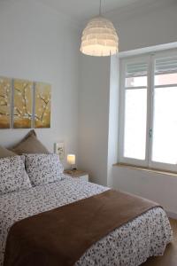 a bedroom with a bed and a large window at FLORIT FLATS - The Ausias March Apartment in Valencia