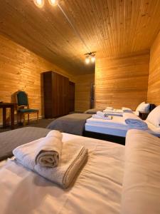 a room with three beds with towels on them at FORREST hotel in Bukovel