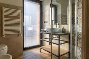 a bathroom with a sink and a shower at Hotel Mon Émile in Aosta