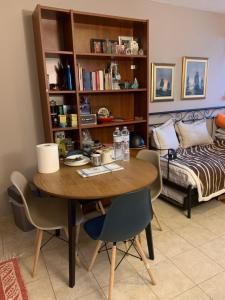 a room with a table and chairs and a bed at Holidays Pelion studio in Nea Anchialos
