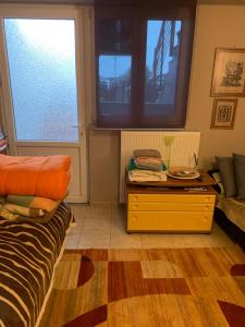 a living room with a couch and a table at Holidays Pelion studio in Nea Anchialos