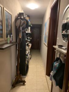 a hallway with a room with a shelf of shoes at Holidays Pelion studio in Nea Anchialos