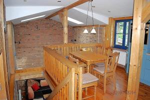 a dining room with a wooden table and chairs at Blankenese in Ahlbeck