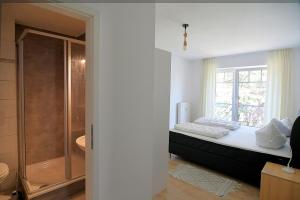 a bedroom with a bed and a window at Wilhelmstr-10-Whg-25 in Ahlbeck