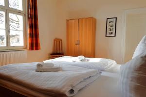 two beds in a bedroom with towels on them at Bellevue-App-05 in Ahlbeck