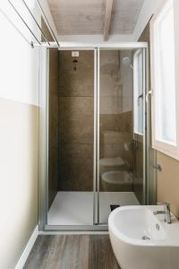 a bathroom with a glass shower and a sink at Natural Village Resort in Porto Potenza Picena