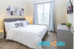 a bedroom with a white bed and a window at Charming Dallas Getaway W Modern Amenities in Dallas