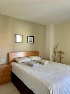 a bedroom with a bed with two books on it at Aura Apartment Benidorm in Benidorm