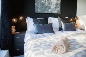 a bedroom with a bed with a towel on it at Ideal Home Away in Whitefield Bury in Manchester