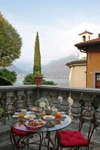 a table with food on top of a stone wall at Palazzo Del Vicerè in Lezzeno