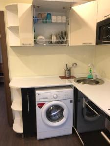 a kitchen with a washing machine and a sink at Квартира ЛЮКС in Balqash
