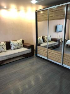 a room with two beds and a mirror at Квартира ЛЮКС in Balqash +1 photo