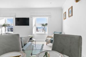 a living room with two chairs and a table at The Seaview Suites and Ground Floor Suite at The Corbyn Apartments in Torquay