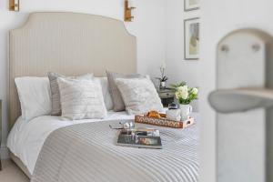 a bedroom with a white bed with a tray on it at Seaview Suite at The Corbyn Apartments in Torquay