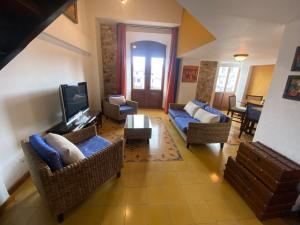 a living room with couches and a flat screen tv at Oasis Hotel in Panama City