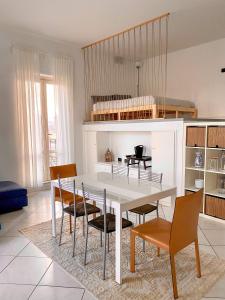 a dining room with a white table and chairs at SanFa Roof in Viterbo