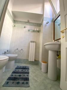 a bathroom with a sink and a toilet at SanFa Roof in Viterbo