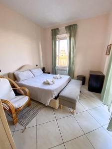 a bedroom with a bed and a chair and a window at SanFa Roof in Viterbo