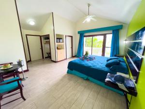 a bedroom with a blue bed and a mirror at Fantasy Island Beach Resort and Marina - All Inclusive in First Bight