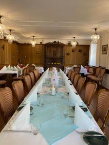 een lange tafel in een kamer met stoelen bij Hotel & Restaurant Zum Riesen in Walldürn
