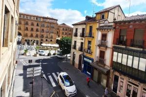 a city street with a white car parked on the street at I Precioso apartamento en el corazón de Salamanca in Salamanca +9 photos