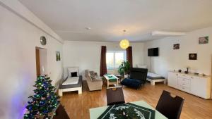 a living room with a christmas tree in it at Ferienwohnung Freund & Berndt in Nermsdorf