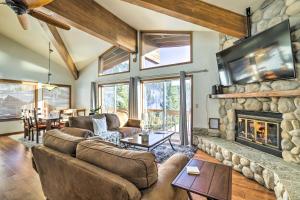 a living room with couches and a stone fireplace at Steps to Diamond Peak Incline Village Condo in Incline Village
