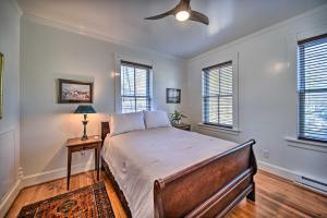 a bedroom with a bed and two windows at Radiant Gloucester House with Private Porch! in Gloucester