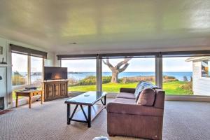 Una sala de estar con un sofá y vista al mar. en Cliffside Lighthouse Beach Home with Ocean View, en Coos Bay
