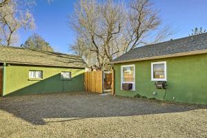 a green and yellow house with a fence at Vibrant Prescott Cottage with Private Backyard! in Prescott