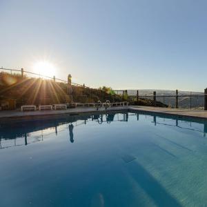 a large swimming pool with the ocean in the background at Sagecliffe Resort & Spa in George