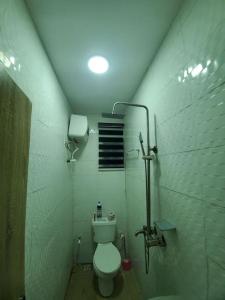 a small bathroom with a toilet in a stall at DINERO DIAMOND - ONE BED APARTMENT in Lagos