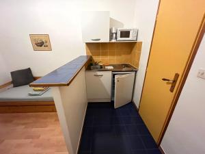 a small kitchen with a stove and a microwave at Studio CV - Calme, clair in Montpellier
