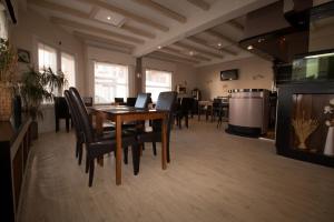 a dining room with a table and chairs at Hôtel Pacific in Calais