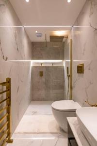 a white bathroom with a toilet and a shower at The Wilton Suite - Your Private 5* Escape! in Glasgow